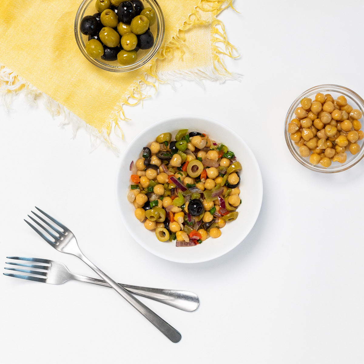 Zina's Fine Foods Chickpea Salad with side dishes of mixed olives and raw chickpeas