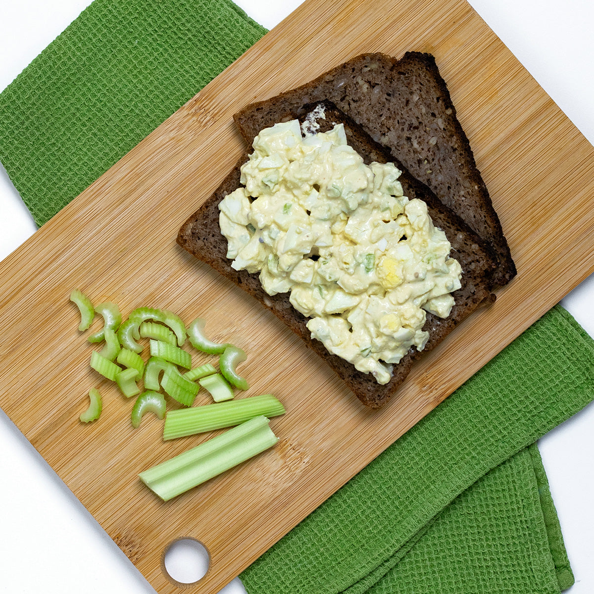 Zina's Fine Foods Classic Egg Salad on dark rye bread with fresh celery sticks