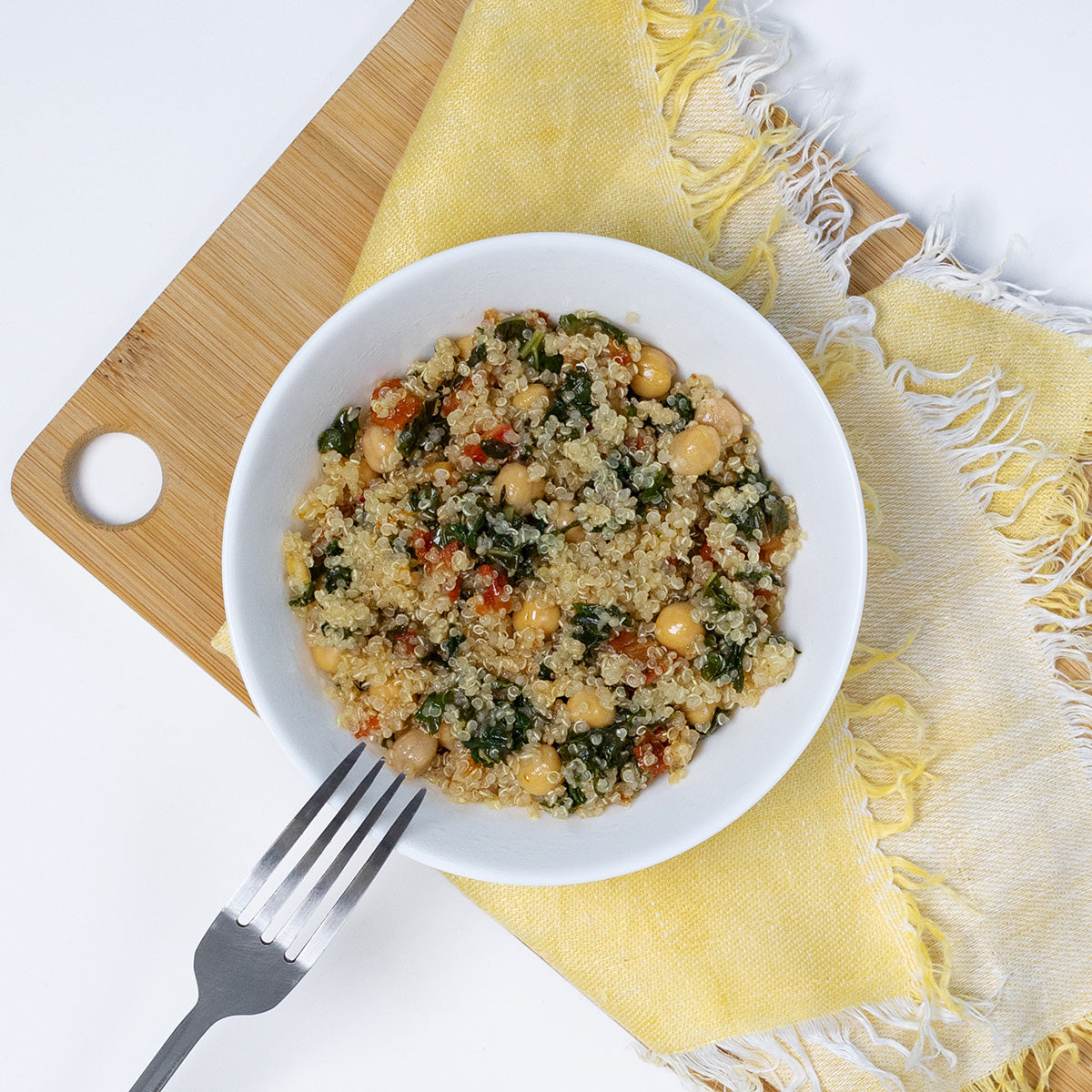 Kale and Quinoa Bistro Salad with quinoa, kale and chickpeas in a white bowl by Zina's Fine Foods